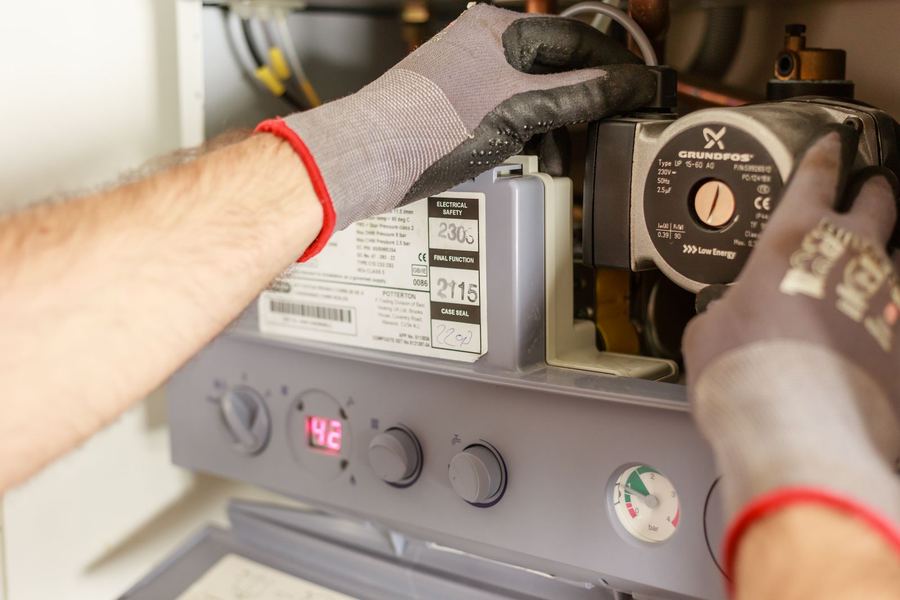 Techniker wartet die Pumpe und Steuerung einer Heizungsanlage